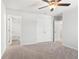 Neutral bedroom features a ceiling fan, closet, ensuite bathroom, and neutral carpet at 4778 Moonstone Trce, Kennesaw, GA 30144