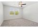Bedroom featuring carpet, two windows providing natural light, and a ceiling fan at 4778 Moonstone Trce, Kennesaw, GA 30144