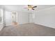 Bedroom featuring carpet, ceiling fan, white doors and a view of wood floors in the adjacent room at 4778 Moonstone Trce, Kennesaw, GA 30144