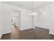 Dining room leads to the kitchen area with bright lighting and wood floors at 4778 Moonstone Trce, Kennesaw, GA 30144