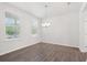 Dining room features modern chandelier, natural light and wood floors at 4778 Moonstone Trce, Kennesaw, GA 30144
