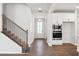 Inviting entryway with wood flooring, stairs, and access to kitchen appliances at 4778 Moonstone Trce, Kennesaw, GA 30144