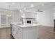 Spacious kitchen island with a sink, modern faucet, and a full view of the dining and fireplace area at 4778 Moonstone Trce, Kennesaw, GA 30144