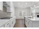 Modern kitchen featuring a stylish backsplash, stainless steel range, and an island with a sink at 4778 Moonstone Trce, Kennesaw, GA 30144