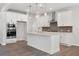 Spacious kitchen features a large island with white cabinets and wood floors at 4778 Moonstone Trce, Kennesaw, GA 30144