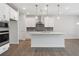 Contemporary kitchen boasts an island, modern appliances, and pendant lighting at 4778 Moonstone Trce, Kennesaw, GA 30144