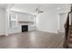 Bright living room with a fireplace, shiplap accent wall, ceiling fan, and hardwood floors at 4778 Moonstone Trce, Kennesaw, GA 30144