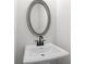 Elegant powder room featuring a pedestal sink and a stylish oval mirror at 4778 Moonstone Trce, Kennesaw, GA 30144
