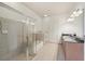 Spacious bathroom with a glass-enclosed shower, separate tub, and double vanity sinks at 711 Cosmopolitan Ne Dr # 802, Atlanta, GA 30324