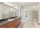 Bathroom showcasing granite countertops, double sinks, and a glass shower at 711 Cosmopolitan Ne Dr # 802, Atlanta, GA 30324
