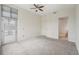 Bedroom with carpeted floors, ceiling fan and exterior door/balcony access at 711 Cosmopolitan Ne Dr # 802, Atlanta, GA 30324