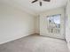 Spacious bedroom showcasing carpeted floors and a large window providing ample natural light at 711 Cosmopolitan Ne Dr # 802, Atlanta, GA 30324