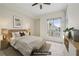 Bright bedroom featuring carpeted floors, ceiling fan, and a large window with natural light at 711 Cosmopolitan Ne Dr # 802, Atlanta, GA 30324