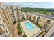 An aerial view of the pool, lounge furniture, and condo building at 711 Cosmopolitan Ne Dr # 802, Atlanta, GA 30324