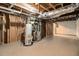 Unfinished basement with exposed ductwork, water heater, and concrete floor, offering potential for customization at 120 E Cainwood E Ct, Atlanta, GA 30349