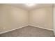 A simple and neutral bedroom with wall-to-wall carpet and a built-in ceiling light at 120 E Cainwood E Ct, Atlanta, GA 30349