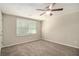Bedroom featuring neutral color walls and carpet with a ceiling fan and window at 120 E Cainwood E Ct, Atlanta, GA 30349