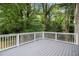Spacious outdoor deck perfect for relaxing and entertaining while overlooking the lush green backyard at 120 E Cainwood E Ct, Atlanta, GA 30349
