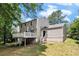 Back exterior view shows a spacious deck overlooking the backyard and access to basement at 120 E Cainwood E Ct, Atlanta, GA 30349