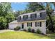 Charming two-story home featuring a gray brick facade, black shutters, and a well-maintained front lawn at 120 E Cainwood E Ct, Atlanta, GA 30349