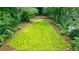 Aerial view of a backyard featuring a moss lawn, surrounded by trees and landscaping at 2811 Alpine Ne Rd, Atlanta, GA 30305