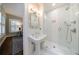 Modern bathroom with a glass shower, subway tile, pedestal sink, and hardwood floors at 2811 Alpine Ne Rd, Atlanta, GA 30305