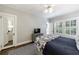 Bedroom featuring a ceiling fan, hardwood floors, shuttered windows, and an ensuite bathroom at 2811 Alpine Ne Rd, Atlanta, GA 30305