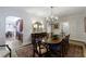 Elegant dining room featuring a chandelier, dark wood table, and an ornate area rug at 2811 Alpine Ne Rd, Atlanta, GA 30305