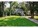 Charming home featuring manicured front lawn, beautiful landscaping, and inviting blue front door at 2811 Alpine Ne Rd, Atlanta, GA 30305