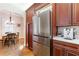 Kitchen featuring wood cabinetry, stainless steel refrigerator and appliances, with a view to a dining nook at 2811 Alpine Ne Rd, Atlanta, GA 30305
