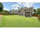 Backyard featuring a green lawn, wooden fence, and a gazebo structure with curtains and a TV at 412 Middlebrooke St, Canton, GA 30115