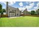 Spacious backyard with green lawn, patio, and a charming wooden gazebo structure at 412 Middlebrooke St, Canton, GA 30115