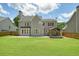 Large backyard featuring a well-maintained lawn, wooden fence, patio, and a gazebo structure at 412 Middlebrooke St, Canton, GA 30115