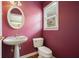 Small half bathroom with pedestal sink and oval mirror at 412 Middlebrooke St, Canton, GA 30115