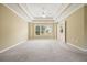 Spacious bedroom featuring plush carpeting, tray ceiling, and large window at 412 Middlebrooke St, Canton, GA 30115
