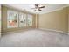 Spacious bedroom featuring plush carpeting, ceiling fan, and three large windows at 412 Middlebrooke St, Canton, GA 30115