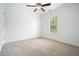 A bright bedroom featuring carpet, ceiling fan, and a window with natural light at 412 Middlebrooke St, Canton, GA 30115