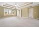 Spacious bedroom featuring plush carpeting, tray ceiling, and large window at 412 Middlebrooke St, Canton, GA 30115