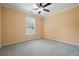 Empty bedroom featuring carpet, ceiling fan, and natural light at 412 Middlebrooke St, Canton, GA 30115