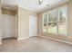 Bright, neutral bedroom featuring tile floor, large windows, and closet space at 412 Middlebrooke St, Canton, GA 30115