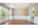 A spacious dining room featuring hardwood floors, chandelier, and large windows at 412 Middlebrooke St, Canton, GA 30115
