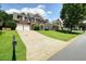 View of a brick home with a long driveway on a grassy lot, neighborhood street view at 412 Middlebrooke St, Canton, GA 30115
