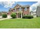 Attractive brick home with a lush green lawn, showcasing its classic architectural details at 412 Middlebrooke St, Canton, GA 30115