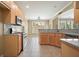 The kitchen showcases granite counters, stainless appliances and wood cabinets at 412 Middlebrooke St, Canton, GA 30115
