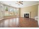 Bright living room with hardwood floors, fireplace, and large windows overlooking the backyard at 412 Middlebrooke St, Canton, GA 30115