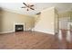Open-concept living room with fireplace, hardwood floors, and staircase leading to the upper level at 412 Middlebrooke St, Canton, GA 30115