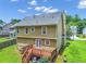 Aerial view of the backyard featuring a wooden deck, lush lawn, and mature trees at 5807 Mitchell Chase Trl, Mableton, GA 30126