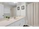 A bright bathroom features a large mirror, white vanity, and shower with curtain at 5807 Mitchell Chase Trl, Mableton, GA 30126