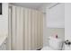 Bathroom featuring a neutral shower curtain and a white toilet near a window at 5807 Mitchell Chase Trl, Mableton, GA 30126