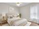 A bright bedroom features a neutral color palette and natural light from a window, creating a relaxing space at 5807 Mitchell Chase Trl, Mableton, GA 30126